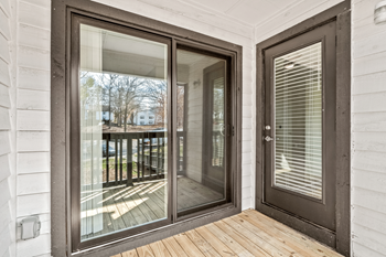 A glass door with a wooden floor and a white wall at Paces Pointe Apartment Homes, North Carolina, 28105
